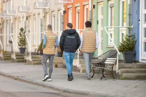 Drie collega's lopen samen op de stoep